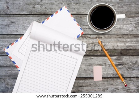 letter paper, rubber and pencil on wooden table background