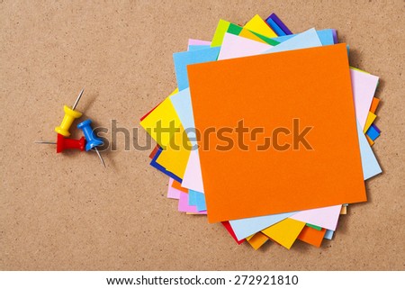 Colorful memo pads on the cork board