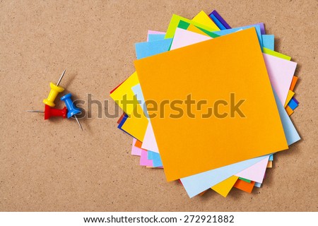 Colorful memo pads on the cork board