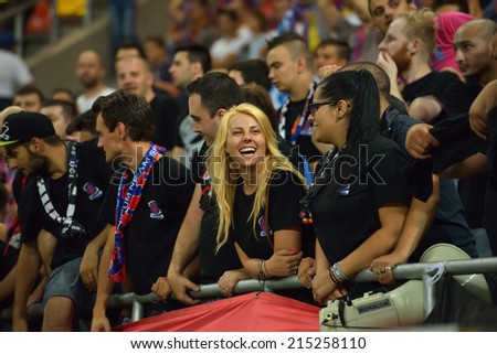 BUCHAREST-AUGUST06:Beautiful blonde girl, supporter of football team Steaua Bucharest during the match with Aktobe Kazakhstan, UEFA Champions League 3rd qualifying round Steaua won 1-0, August 06,2014