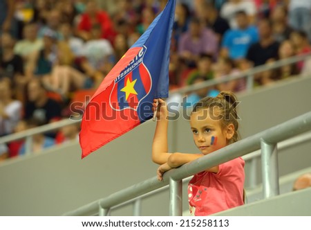 BUCHAREST-AUGUST06:Beautiful young girl, supporter of football team Steaua Bucharest during the match with Aktobe Kazakhstan, UEFA Champions League 3rd qualifying round Steaua won 1-0, August 06,2014