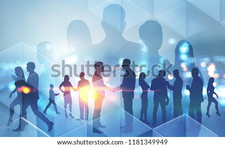 Business people silhouettes walking, talking and shaking hands over night city background. Partnership and sealing a deal concept. Toned image double exposure copy space
