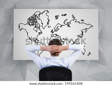 Sitting businessman and the world map