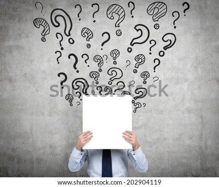 Businessman trying to find a solution. Businessman is holding an empty banner surrounded by question marks - metaphor of a new innovation idea.