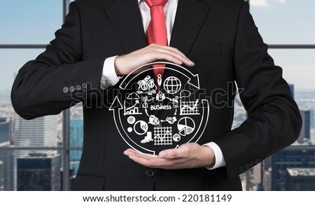 Businessman is holding the flow chart and trying to imply it into a new start up project.