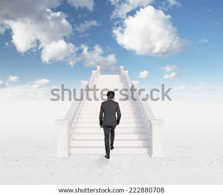 A concept of successful career. Businessman is climbing on the top of the world.