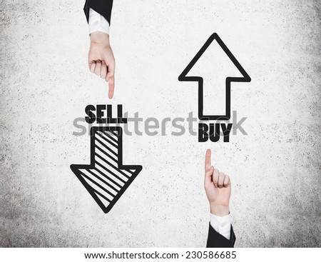Two hands are pointing out the choices \'sell or buy\'.