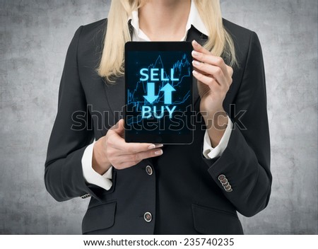 businesswoman holding touch pad with stock chart