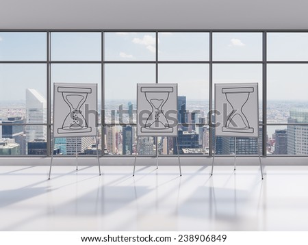 office with three stand with drawing sand watch