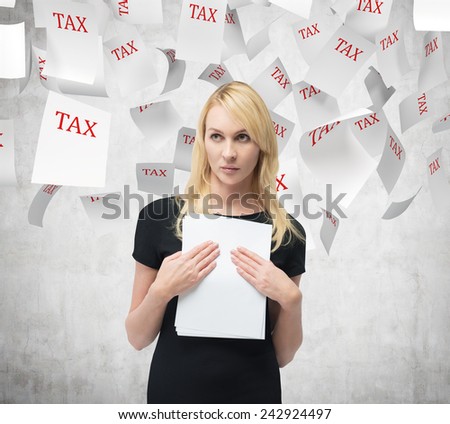 businesswoman with document in hand and falling tax papers