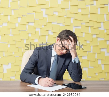 tired businessman working in office and many sticker
