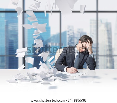 businessman working in office and falling tax papers
