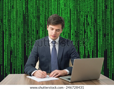 young businessman working in office on matrix background