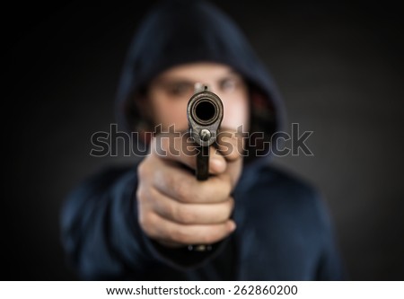killer with gun  isolated on a black background