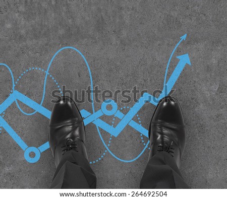 businessman standing on drawing stock chart on floor