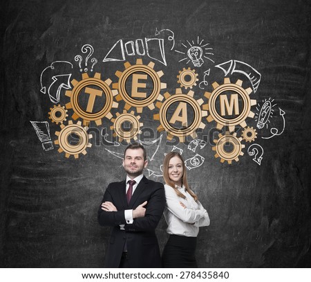 Business couple are thinking about cooperation in a business project. Drawn gears on the wall with the word team. The concept of the team working.