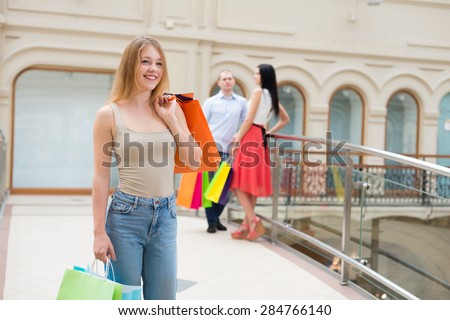 Young people with a lot of bags from the fancy shops. Shopping, sale, gifts and holidays concepts. High-street shopping.