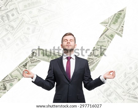 Meditative businessman. Dollar notes background with the growing arrow made from dollar notes.
