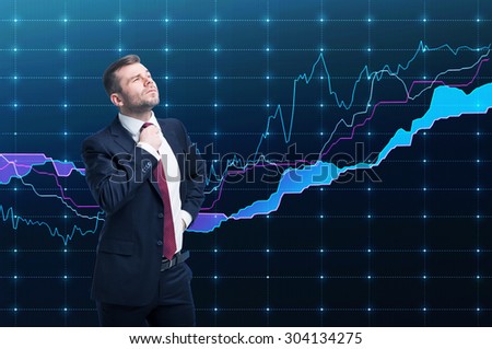 Closeup of successful portfolio manager in formal suit. A concept of decision making process in finance. Forex chart is on the background.