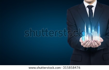 A person holds a hologram of skyscrapers as a symbol of financial success.