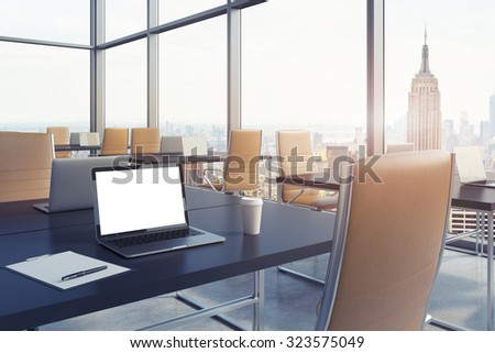 Workplaces in a modern corner panoramic office in New York. Black tables and brown leather chairs. A laptop with a white screen, notepad and a coffee cup. 3D rendering. Toned image.
