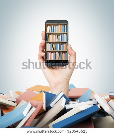 A hand holds a smartphone with a book shelf on the screen. A heap of colourful books. A concept of education and technology. Light blue background.
