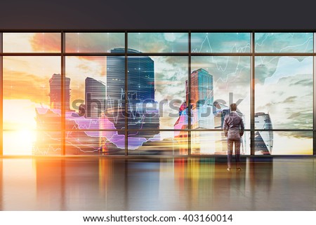 Businessman with hands in pockets standing at panoramic window. Office, night. Moscow city view. Double exposure. Concept of thinking.