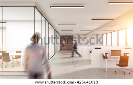 Blurry business man walking inwhite  office interior with sunlight. Woman on background. Law office.