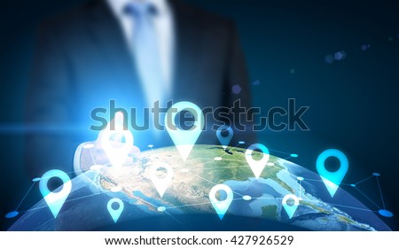 Traveling concept with businessman pointing at globe with location pin network on dark background. Elements of this image furnished by NASA