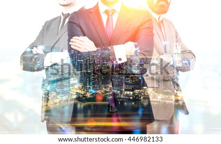 Teamwork and partnership concept with businesspeople crossing arms on illuminated Singapore city background at night. Double exposure