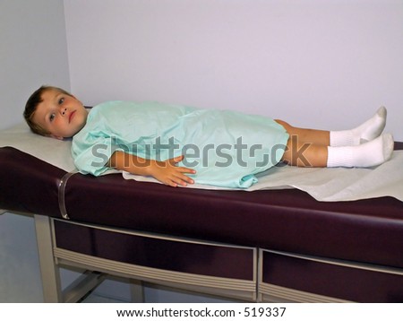 sick little boy on examining table - full body