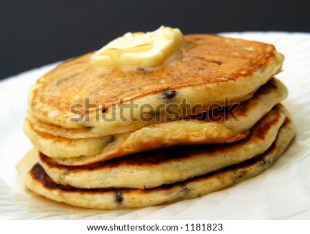 stack of chocolate chip pancakes with butter and syrup