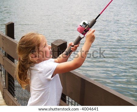 little girl fishing from the docks with a pink fishing pole
