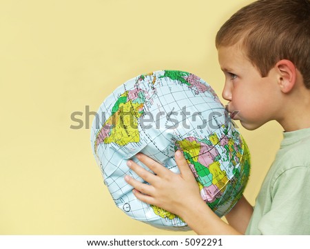 young boy breathing life back into a deflating planet earth