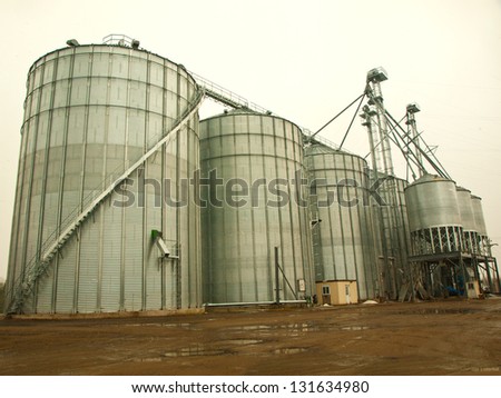 work-site with industrial silos on a rainy day