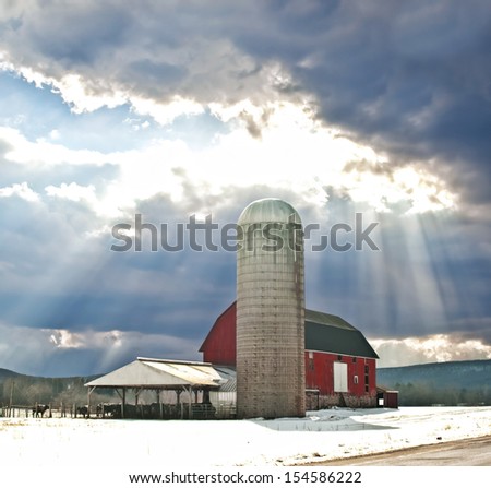 barn in winter with sun-rays
