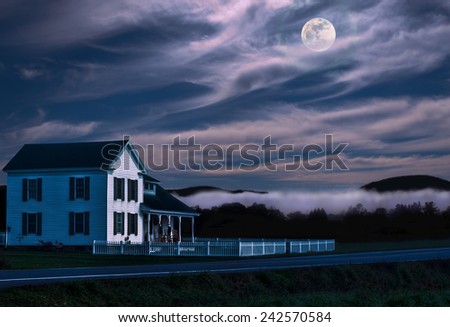 white house with picket fence on a moonlit night in the countryside