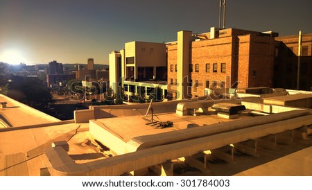 rooftop view of buildings and city at sundown