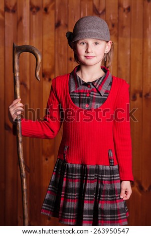 Little girl standing and shepherd holding a shepherd\'s staff. Farm