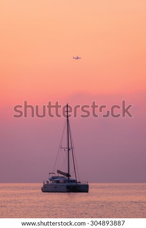 Sailing catamaran on a background of beautiful sunrise in the ocean Outdoors