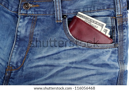 money dollars and brown leather wallet in jeans in front pocket blue color background