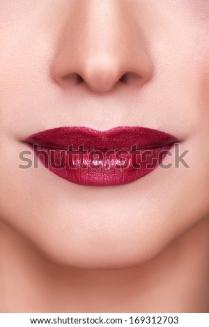 Beautiful Sensual Red Lips Macro Shooting. Professional Make Up. Red Lipstick. Toned And Clean Skin