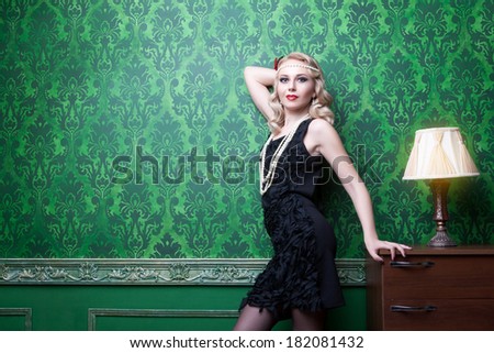 Sensual beautiful blonde in green vintage room. Professional make up and hairstyle. Vintage green interior.