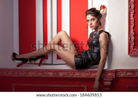 Sexy glamour girl in red vintage room. Professional make up and hairstyle