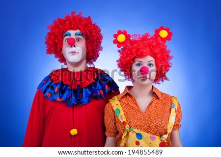 Clown couple on blue background. Professional studio lighting