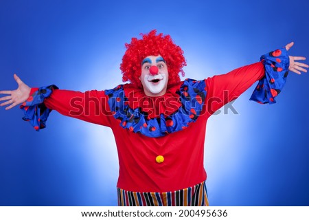 happy clown on blue background. Professional lighting. Humor. Carnival