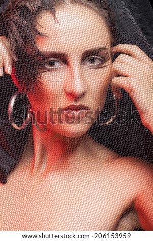 Gorgeous woman with gothic make up. Professional art style fashion goth make up. Studio lighting. Feather theme