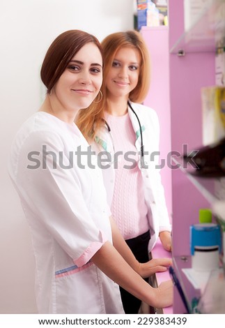 Two pharmacist woman behind the desk waiting for the clients. Healthcare business. Business. Medicine and Pharmacy