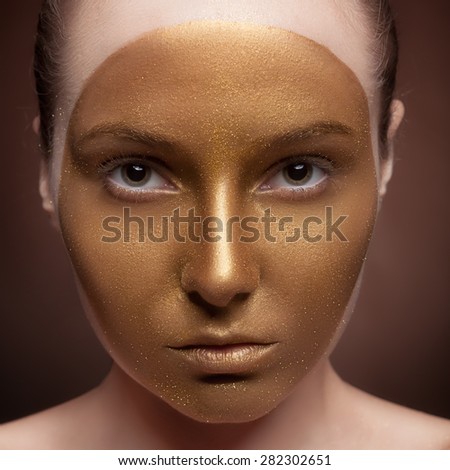 Woman with artistic make up on face on brown background. Art fashion make up. Perffect skin with texture. Creativity