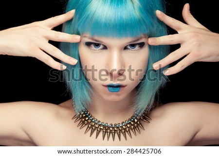 Girl with blue hair and make up over black background. Fashion make up and beauty. Anime style